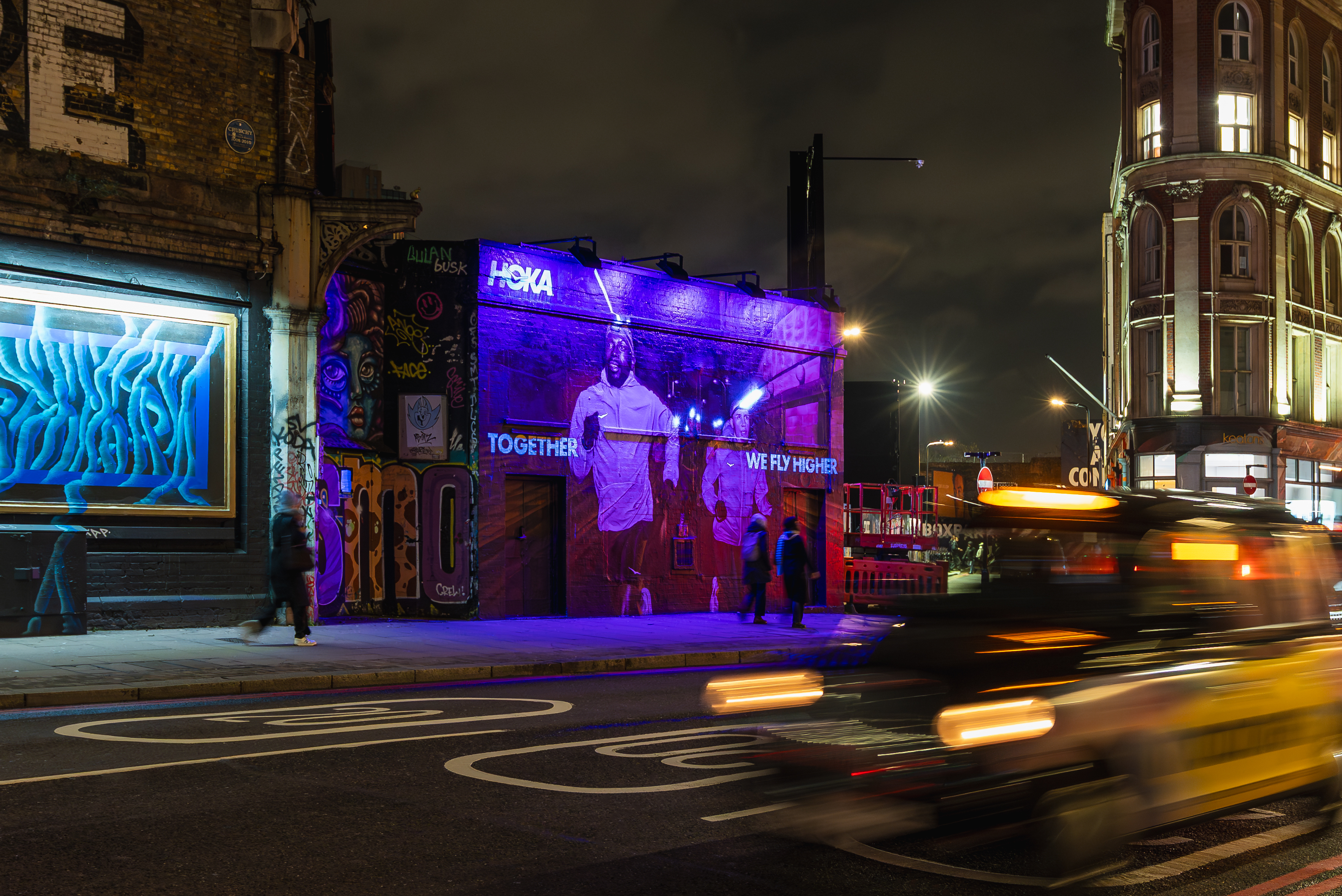 HOKA light-reactive mural in East London at night