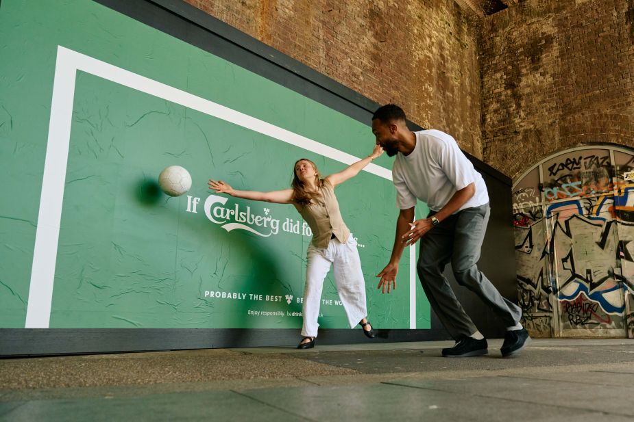 People playing football with Carlsberg Goal Posters activation